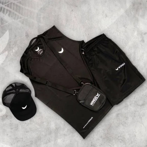 Flat lay of black Wings kit: cap, crossbody bag, tank top and shorts